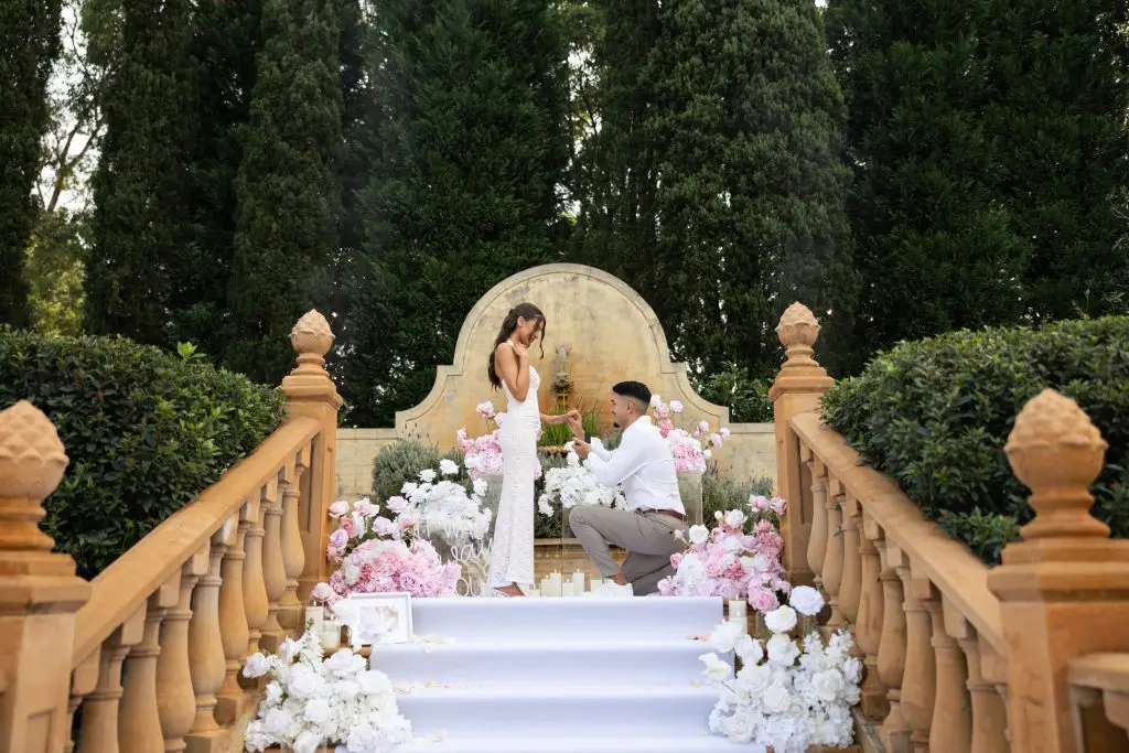 pink and white floral proposal on mediterranean staircase
